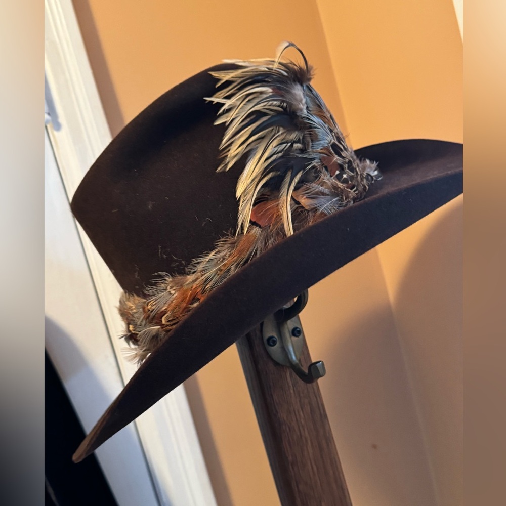 Resistol cowboy hat with fancy removable feather hat band. Purchased in Wyoming